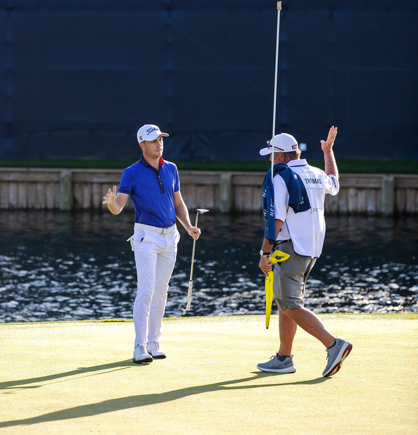 Justin Thomas celebrates with his caddie after winning THE PLAYERS Championship on Sunday, March 14 at THE PLAYERS Stadium Course at TPC Sawgrass.